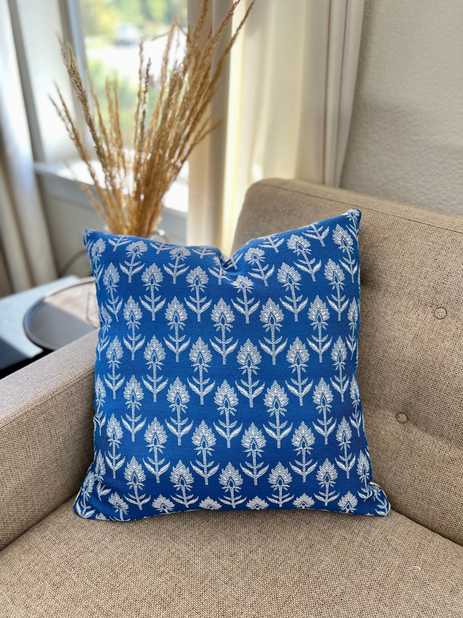 Blue white pillow coveron an indoor sofa