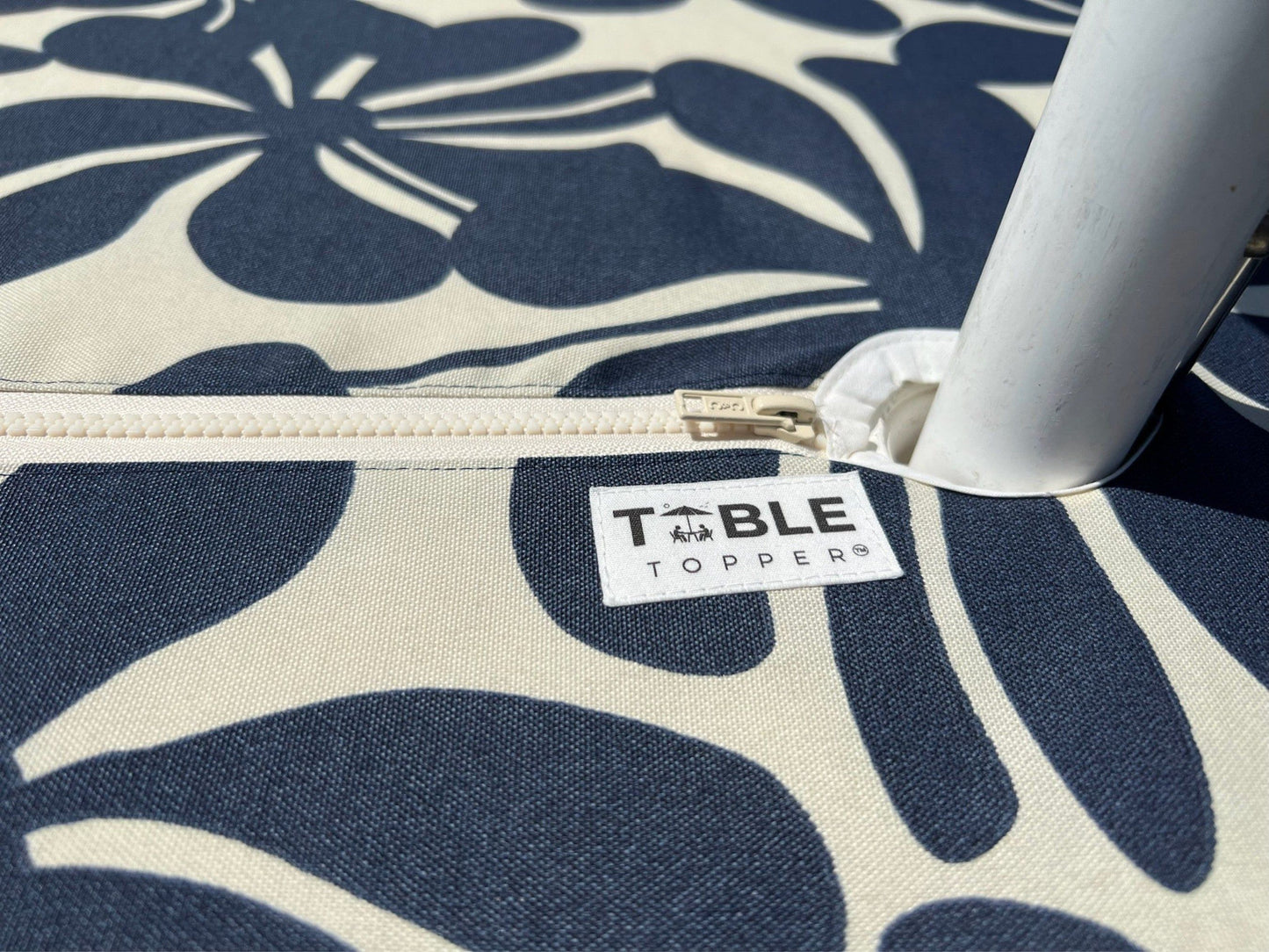 Closeup of the umbrella hole zipper feature for the TableTopper fitted tablecloth